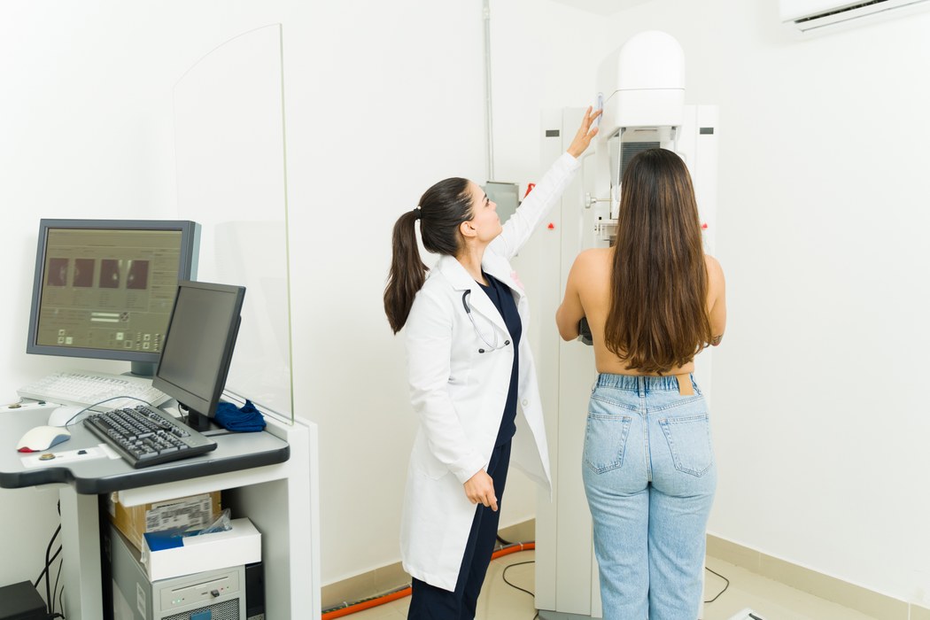 Foto af kvindelig patient der får scannet sine bryster af en kvindelig læge